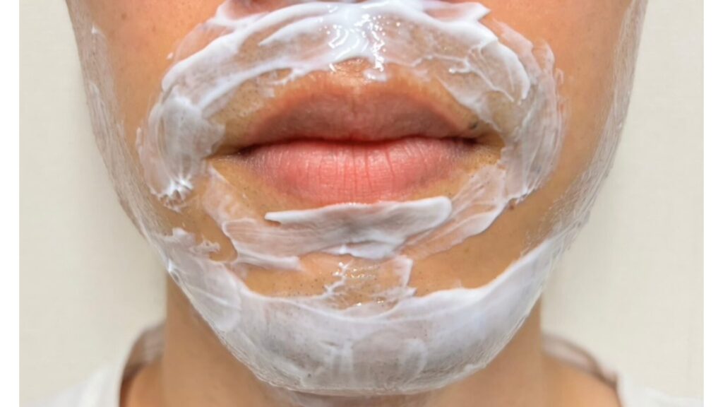 Applying anesthetic cream to the face